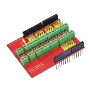 Prototyping circuit board with terminal blocks and pin headers for electronics projects.